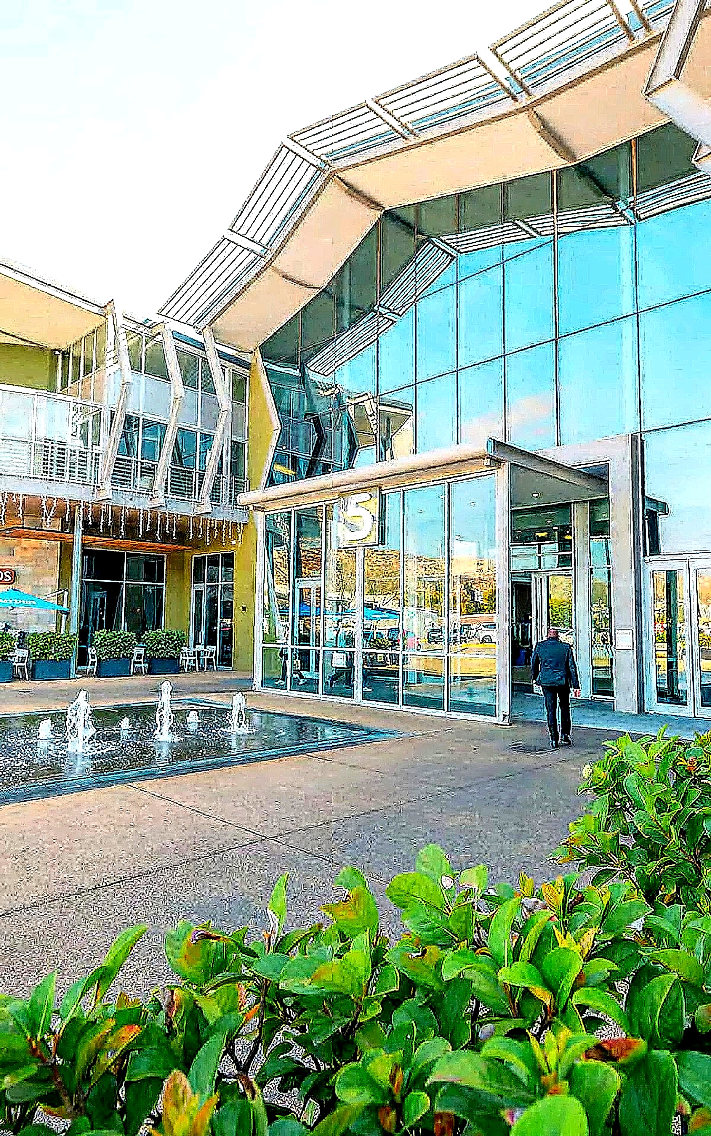 The main entrance of Cradlestone Mall, lit by the morning sun