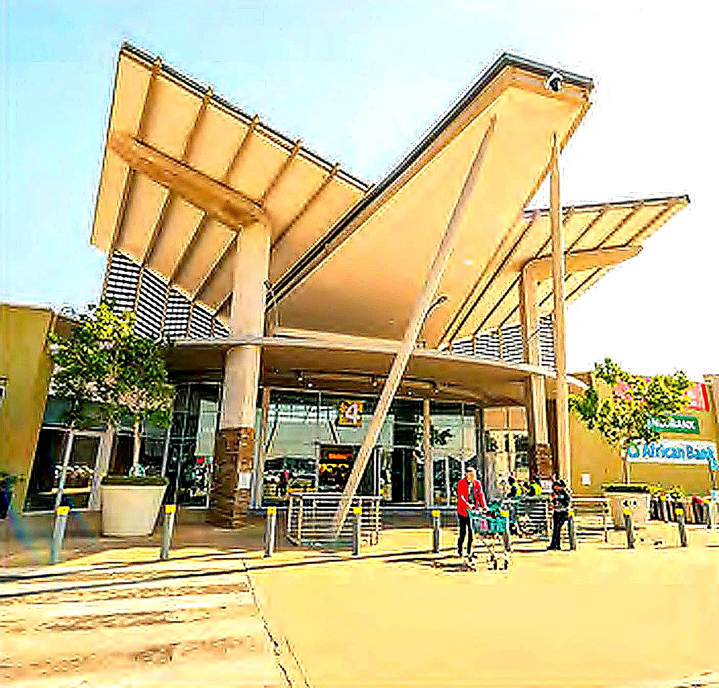 A major mall entrance beneath its cantilevered geometric roof