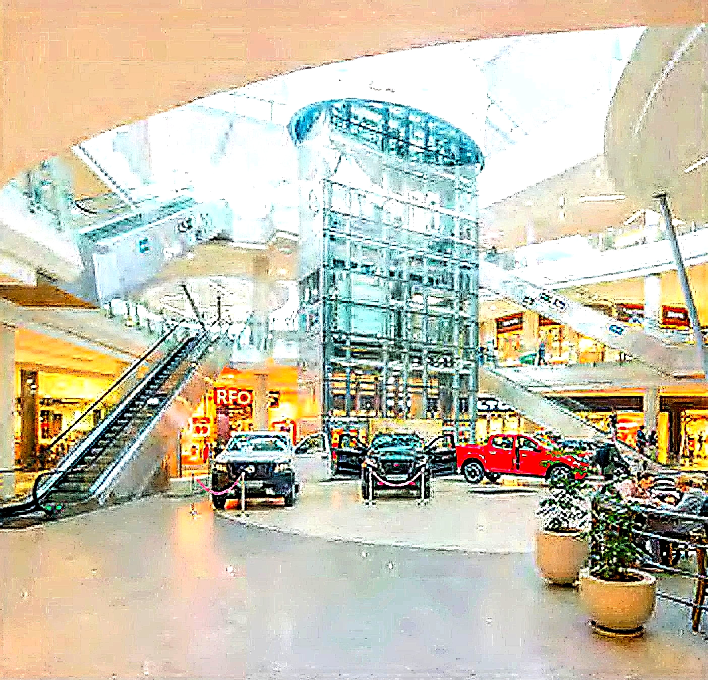 The cylindrical glass elevator shaft and open lobby area